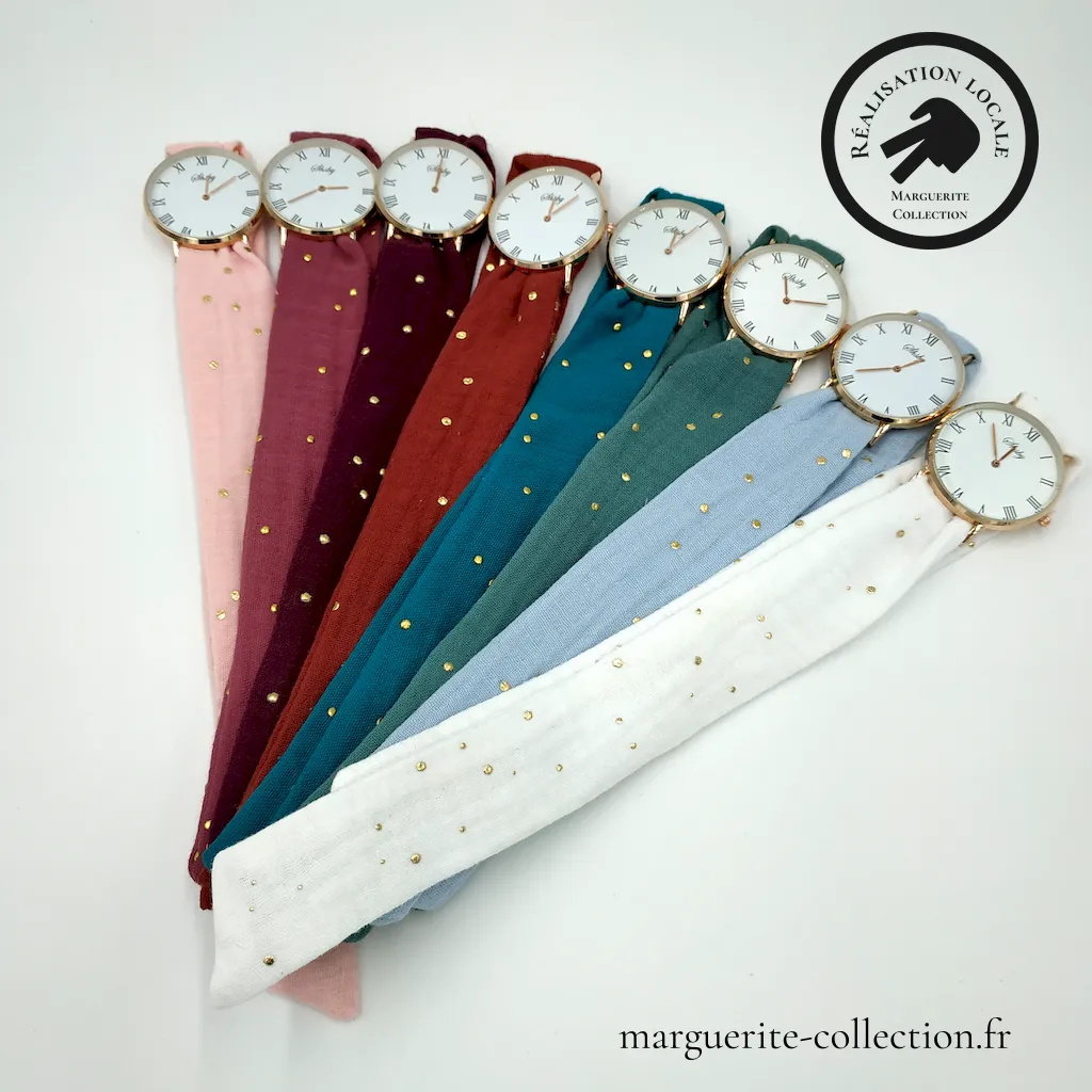 Marguerite-Collection_montresdoublegazepoisdores_173403 Marguerite Collection montresdoublegazepoisdores 173403 - Montre à nouer "Auréa" Double Gaze & Pois Dorés Montre artisanale à bracelet double tour en coton double gaze. Cadran doré (32,5 mm ou 37 mm) avec chiffres arabes ou romains, pile incluse. Un modèle confortable et élégant, à nouer simplement autour du poignet. - 20,00 €