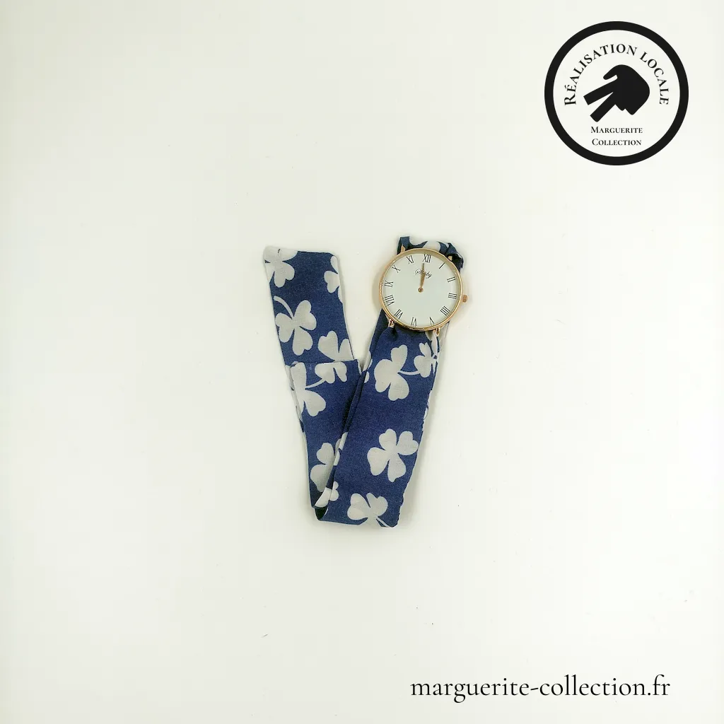 Marguerite-Collection_Montre_Dorée_Maxi_L'élégante_trèfles_WEBP Marguerite - Montre à nouer "L'élégante" pour femmes. Avec un bracelet en tissu viscose de qualité. Plusieurs choix possibles de bracelets. Plusieurs types de cadrans proposés: Maxi dorée, Maxi argentée et Mini dorée. - 28,00 €